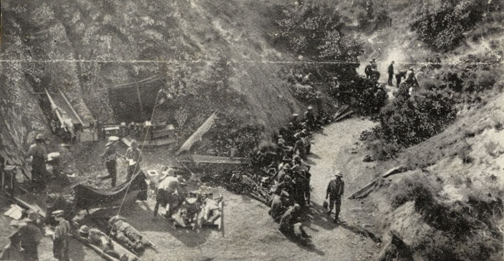 Advanced Dressing Station near Rhododendron Ridge. Wounded are lying on stretchers ready to be taken to ships waiting out at sea.